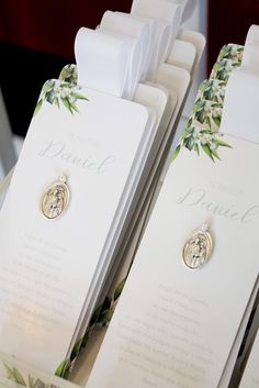 a close up of some cards with brooches attached to them on a table