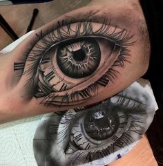 an eye tattoo on the arm and leg