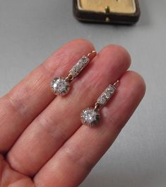 Antique 14K yellow and white gold drop earrings with diamonds, lever back. With an Austrian hallmark that was used between 1867 and 1937. Gemstone: Natural diamond, 2 pieces Weight: 1.3 carat Color: Crystal (I/J) Clarity: SI2 Measurements: Round, 5.8 x 3.16 mm each Cut: Old Cut Brilliant Finish: Corresponds to old cut requirements Fluorescence: none Not treated. Additional stones: Natural diamond, 6 pieces Measurements: 2.4 mm Weight: 0.3 carat Cut: Old Cut Brilliant Color: Crystal (I/J) Clarity Victorian Diamond Earrings With Prong Setting For Anniversary, Victorian Brilliant Cut Diamond Earrings For Anniversary, Vintage White Gold Diamond Cut Earrings, Antique Brilliant Cut Diamond Earrings For Anniversary, Antique Diamond Earrings With Prong Setting, Vintage White Gold Diamond Earrings With Prong Setting, Vintage White Gold Diamond Earrings With Brilliant Cut, Victorian Diamond Earrings With Prong Setting, Hallmarked Vintage Diamond Earrings