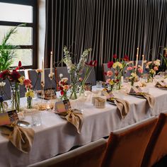 a long table is set with flowers and place settings for an elegant dinner party or celebration