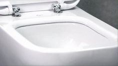 a close up view of a toilet with the lid down and two handles on it