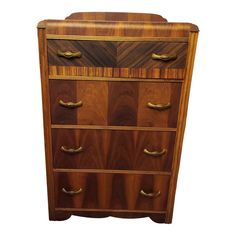 an antique chest of drawers with brass handles