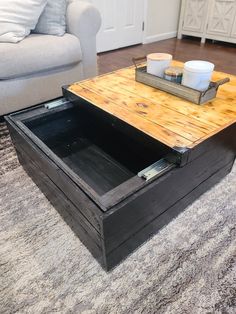 a coffee table with an open drawer underneath it on a rug in a living room