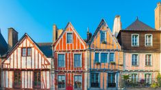 several old buildings are lined up against the blue sky