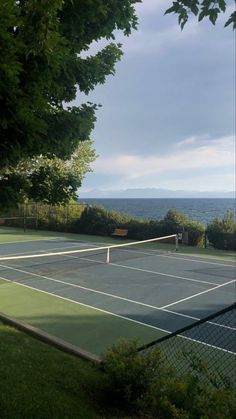 two tennis players are on the court with their rackets in hand and one is ready to hit the ball