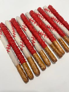 several red and white decorated donuts are lined up in a row on top of each other