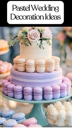 A pastel wedding cake decorated with soft blush and lavender macarons, topped with delicate pink roses and greenery, placed on a teal cake stand. Surrounding the cake are matching pastel macarons and whipped cream treats, showcasing elegant pastel wedding decoration ideas for dessert tables.