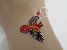 This pair of colorful Cardinals will have you ready to lend an ear for each is made of sterling silver with vibrant, cloisonné enamels and sports a red, Swarovski crystal atop each wing for added interest. Each earring measures 1.5 inches in length from the French hook ear wire to the bird's wingtip and is .75 inch in width from beak to tail. You'll find them to be in excellent, like new condition and although the back is covered with enamel they are guaranteed to be of sterling character. Even Red Enamel Drop Earrings, Red Enamel Pierced Earrings, Red Enamel Earrings, Collectible Enamel Jewelry With Matching Earrings, Red Pierced Enamel Earrings, Red Enamel Collectible Jewelry, Adjustable Enamel Pierced Jewelry, Adjustable Pierced Enamel Jewelry, Adjustable Enamel Jewelry