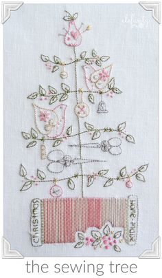 the sewing tree is on display in front of a white background with pink flowers and green leaves