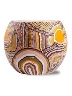 a bowl with an abstract design on the outside and yellow in the top half, sitting on a white surface