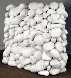 a large pile of white rocks sitting on top of a carpeted floor next to a wall