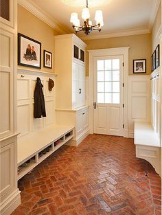 a hallway with brick flooring and white walls