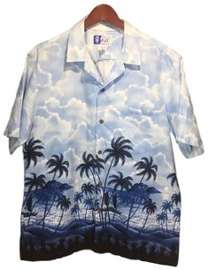 RJC Blue Black Coconut Beach Palm Trees Print Cotton Hawaiian Shirt Men's Size L ITEM DESCRIPTION: Getting decked out for good times is as easy as popping on this shirt. Done in our legendarily comfortable cotton Classic fit:  Cut with a little extra room through the chest and body for relaxed comfort Button-down collar Short sleeve Print-matched left chest pocket Fabric: 100% Cotton Approx. year of Production: 1980 -1990 Buttons: 5 / coconut / vertical holes Presence of top stitiching: Yes Made Blue Summer Camp Shirt For Beach, Blue Shirt For Beach Vacation, Blue Summer Shirt For Vacation, Summer Blue Camp Shirt For Vacation, Blue Summer Camp Shirt For Vacation, Summer Vacation Blue Camp Shirt, Summer Blue Shirt For Beach, Blue Summer Shirt For Beach, Blue Summer Beach Shirt