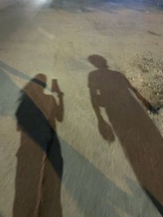 the shadow of a person holding a skateboard