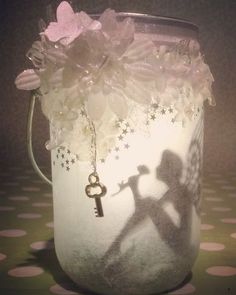 a mason jar filled with flowers and a key