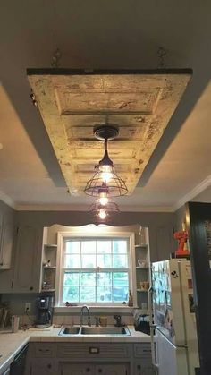 a kitchen with an old light fixture hanging from the ceiling