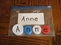 two magnets sitting on top of a piece of paper with the word anne written on them