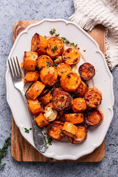 a white plate topped with cooked sweet potatoes