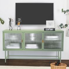 a green cabinet sitting in front of a tv