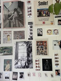 a refrigerator covered in pictures and magnets next to a potted plant on top of it