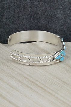 This beautiful opalite and sterling silver bracelet was made by Zuni silversmiths Derrick & Lorella Chavez. The back is signed and stamped sterling.Size: 5 1/4" (will fit up to a 6 1/2" wrist)Gap: 1 1/4"Width: 3/8"Free shipping on all orders! We ship with USPS and always include tracking. All orders ship within a day of payment.Returns are accepted up to 30 days after you receive your order. Just send us a message. Our shop offers cash back or store credit. The item must be returned in new condi Adjustable Sterling Silver Jewelry With Inlay, Sterling Silver Inlay Bracelets In Silver Color, Silver Opal Jewelry For Collectors, Collectible Silver Opal Jewelry, Adjustable Sterling Silver Bracelet With Inlay, Sterling Silver Bracelet, Native American Jewelry, Free Jewelry, Sterling Silver Bracelets