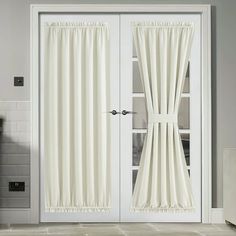 a white door with two windows and curtains