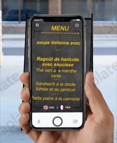 a person holding an iphone in their hand with the text menu displayed on its screen