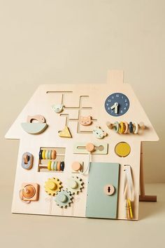 a wooden house with buttons and magnets on it