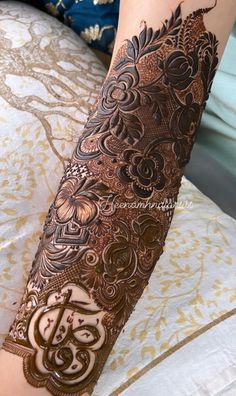 a woman's arm covered in hennap with intricate designs on the arms