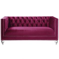 a purple couch with silver legs and buttons