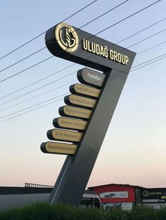 a sign for the uludag group in front of power lines