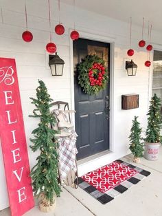 the front porch is decorated for christmas with wreaths and decorations