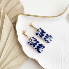 Featuring traditional Mexican Talavera pottery, the Beatriz Earrings are handmade with expert artistry from Mexico City to create a modern, bohemian style. A perfect accessory for any occasion, these one-of-a-kind White and Blue Talavera earrings will add a unique touch to your look. These statement earrings are embellished with 14K gold. They are 2 inches in length; Talavera is 1 1/2 inches. Hand Painted Bohemian Earrings For Everyday, Hand Painted Bohemian Jewelry For Everyday, Bohemian Hand Painted Jewelry For Everyday, Artisan Blue Earrings, Artisan Blue Earrings With Artistic Design, Hand Painted Artisan Jewelry For Everyday, Artisan Hand Painted Everyday Jewelry, Everyday Artisan Hand Painted Jewelry, Bohemian Blue Earrings With Artistic Design