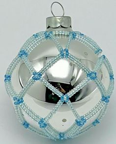 a glass ornament with blue beads on the bottom and silver ball in the middle