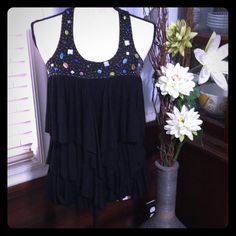 American Rag Sleeveless Black Ruffled And Beaded Top, Nwt Black Ruffled Sleeveless Tank Top, Black Sleeveless Ruffled Tank Top, Sleeveless Black Ruffled Tank Top, Black Ruffled Tank Top, Black Ruffled Tank Top For Party, Ruffled Top, Beaded Top, American Rag, Black Ruffle