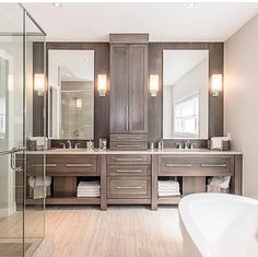 a large bathroom with two sinks and a bathtub next to a walk in shower