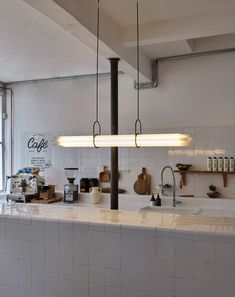 the lights are hanging over the kitchen counter