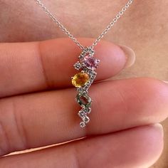 Materials: 18k White Gold Gemstone: Genuine Yellow Sapphire, Green Sapphire, Pink Sapphire, and Diamonds Total Multi-Color Sapphire Carat Weight: 3 sapphires totaling 0.85 ct. Total Diamond Carat Weight: 16 diamonds = 0.14 ct.  Pendant Diameter: 21mm x 6mm Diamond Clarity: SI 1-2 Diamond Color: G-H color Description: This listing is for the pendant only, the necklace is not included. These are genuine gemstones and diamonds, not lab grown An elegant pendant with pink sapphire, green sapphire, and yellow sapphire. Diamonds are elegantly placed around the sapphires to give that extra sparkle. A unique design for everyday wear or for a night out. This beautiful piece will not tarnish in the shower and will not irritate the skin. It will arrive in a jewelry box, with a jewelry bag for travelin Fine Jewelry Gemstone Pendant With Accent Stones, Cubic Zirconia Pendant Fine Jewelry, Fine Jewelry Diamond Pendant Gemstones, Multicolor Sapphire Jewelry With Accent Stones, Fine Jewelry Sapphire Necklace With Accent Stones, Sapphire Necklace With Diamond Accent Stones, Sapphire Diamond Necklace With Accent Stones, White Gold Diamond Pendant, Sapphire Necklace With Gemstone Accents For Anniversary