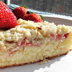 there is a piece of cake with strawberries on it