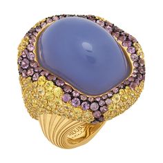 Blue Chalcedony 32.10 Carat Yellow Purple Sapphires 18 Karat Yellow Gold Ring Absolutely spectacular Blue Chalcedony Cabochon-shape weighing 32.10 Carat in our Ring from "New Age" Collection. It surrounded by 18 Karat Yellow Gold and a mix of 96 Purple Sapphires weighing 3.02 Carat and 208 Yellow Sapphires weighing 7.71 Carat inspires thoughts about something mystic. Therefore, you can wear our ring for completely different events. In set with Earrings LU1164115092002. Please request a video link to check this beauty in action US Size 7 3/4// 55 7/8 EU Size 30 x 32.40 mm (WxH) Weight - 26.08 gm. Purple Sapphire Ring, Purple Stone Rings, Purple Ring, Vintage Cocktail Ring, Purple Rings, Purple Diamond, Gold Solitaire Ring, Purple Sapphire, Sapphire Diamond Ring