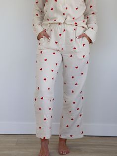 This adorable two piece pajama set features a heart detail featured throughout for a fun and festive look. Not just for Valentine's Day, these adorable pajamas will have you feeling all the love year round. A classic button front top and easy pull on pant provide a breezy and lightweight lounge option thanks to the gauze fabrication. Two piece pajama set Heart printed Button front top Pull on pants Pockets on pants Top Body length measurement: 25" from a M. Bust measurement: 21.5" from a M. Bott Button Front Top, Pj Sets, Pull On Pants, Heart Print, Gucci Bag, Pajama Set, Pajamas, Two Piece, Valentines Day