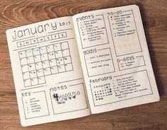 an open planner sitting on top of a wooden table