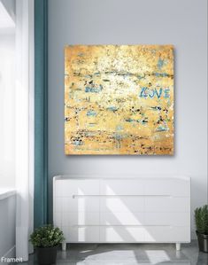 a painting on the wall above a white dresser in a room with blue and yellow walls