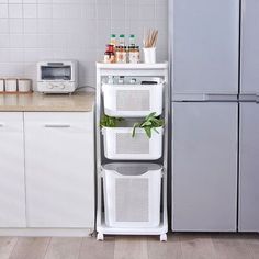 a kitchen with white cabinets and gray refrigerator freezer sitting next to it's door