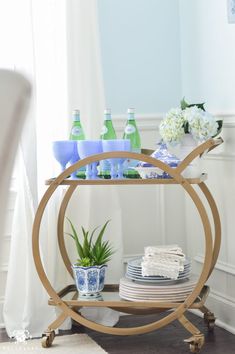 a table with plates, cups and vases on it