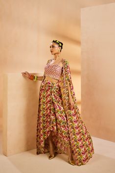 Featuring a wrap skirt and a cape set with our modern botanical print pattern. The bustier is embroidered with metallic sequences and thread embroidery.From Aneesh Agarwaal's Seher collection.DELIVERY TIMEPlease allow 8-12 weeks for your outfit to arrive.FABRIC DETAILSCrepe SilkProfessional cleaning only. Party Sets With Draped Floral Embroidery, Party Sets With Floral Embroidery And Draped Shape, Bohemian Party Sets With Cape Sleeves, Multicolor Party Sets With Long Skirt, Traditional Silk Lehenga For Summer, Silk Lehenga With Traditional Drape For Summer, Bohemian Party Set With Long Skirt, Bohemian Fitted Sets With Cape Sleeves, Silk Sets For Summer Reception