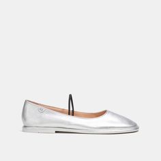 A modern take on a timeless style our go-with-everything Emilia Mary Jane is a super-lightweight design crafted of supple metallic leather. Finished with a sleek elastic band the slip-on flat features a cushiony foam footbed for all-day comfort and a rubber sole for great traction. | Coach Emilia Mary Jane In Silver Metallic - Women's Size 7 Modern Slip-on Ballet Flats For Summer, Silver Slip-on Flats With Removable Insole, Sleek Slip-on Ballet Flats For Spring, Silver Leather Ballet Flats For Spring, Casual Coach Slip-on Flats, Modern Slip-on Flats For Summer, Modern Summer Slip-on Flats, Elegant Metallic Flats For Spring, Chic Silver Leather Flats