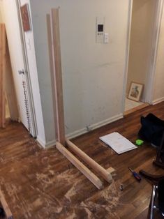 a room that is being remodeled with wood flooring and construction materials on the ground