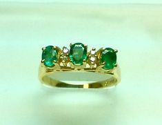 4 x 3 mm oval emerald x 3 0.60 CT emerald 0.06 CT diamond Size : 6 - sizable Only 1 left !! Our beautiful green stone is called Emerald and it is in an oval shape . It is surrounded by 4 brilliant diamonds and placed into a gorgeous 14 K yellow gold ring . It is a very fine quality,natural stone . Available in ruby and sapphire upon request . Attention : We ship out items with USPS-registered mail or UPS Ground depending on location and requires the buyer's signature as well. $15 shipping in the Oval Three-stone Emerald Ring For Formal Occasions, Oval Three Stone Emerald Ring For Formal Occasions, Oval Emerald Three-stone Diamond Ring, Oval Emerald Three Stone Diamond Ring, Oval Emerald Diamond Ring With Three Stones, Alexandrite Necklace, Sentimental Jewellery, Ruby And Sapphire, Emerald Diamond Ring