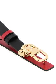 Reversible belt realized in smooth calf leather characterized by metal Gancini buckle. - Adjustable snap-fit closure - Contrasting interior Composition: Exterior: 100% Calf Finishing: Golden metal | Ferragamo Women's Black Leather Reversible Belt in Black/Flame Red | SS24 Modern Calf Leather Belt With Buckle Closure, Modern Leather Belt With Metal Pin Buckle, Luxury Leather Belt Buckle With Metal Logo, Luxury Leather Belt With Metal Logo, Leather Belt Buckles With Metal Logo For Business, Business Leather Belt Buckles With Metal Logo, Designer Business Belt Buckles With Metal Logo, Designer Belt Buckle With Metal Logo, Designer Business Belt Buckle With Metal Logo